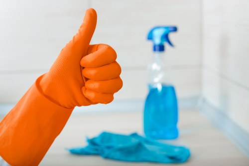Cleaner washing windows and frames on a Westkensington home