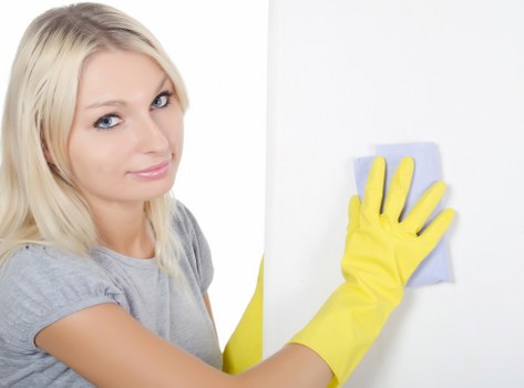 Local cleaner carrying out routine maintenance in a Westkensington flat